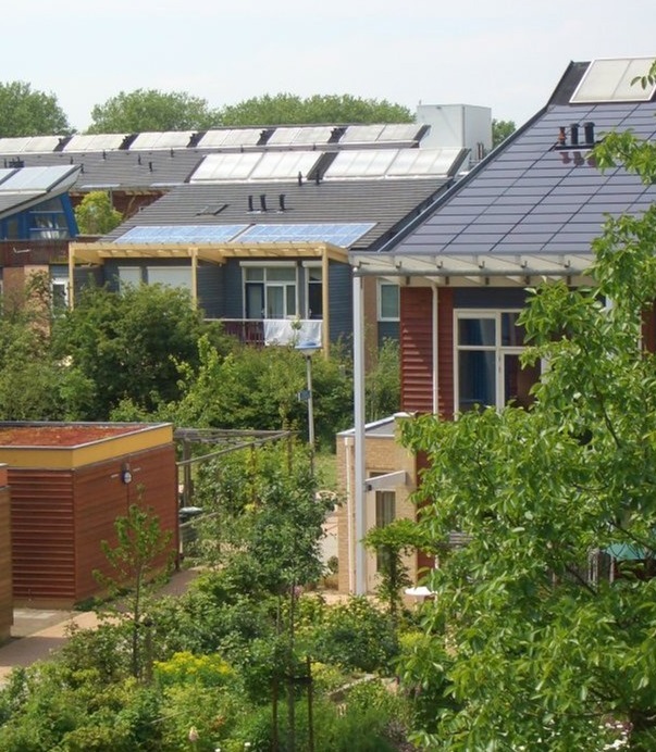 Woonhuizen met zonnepanelen in een groene omgeving