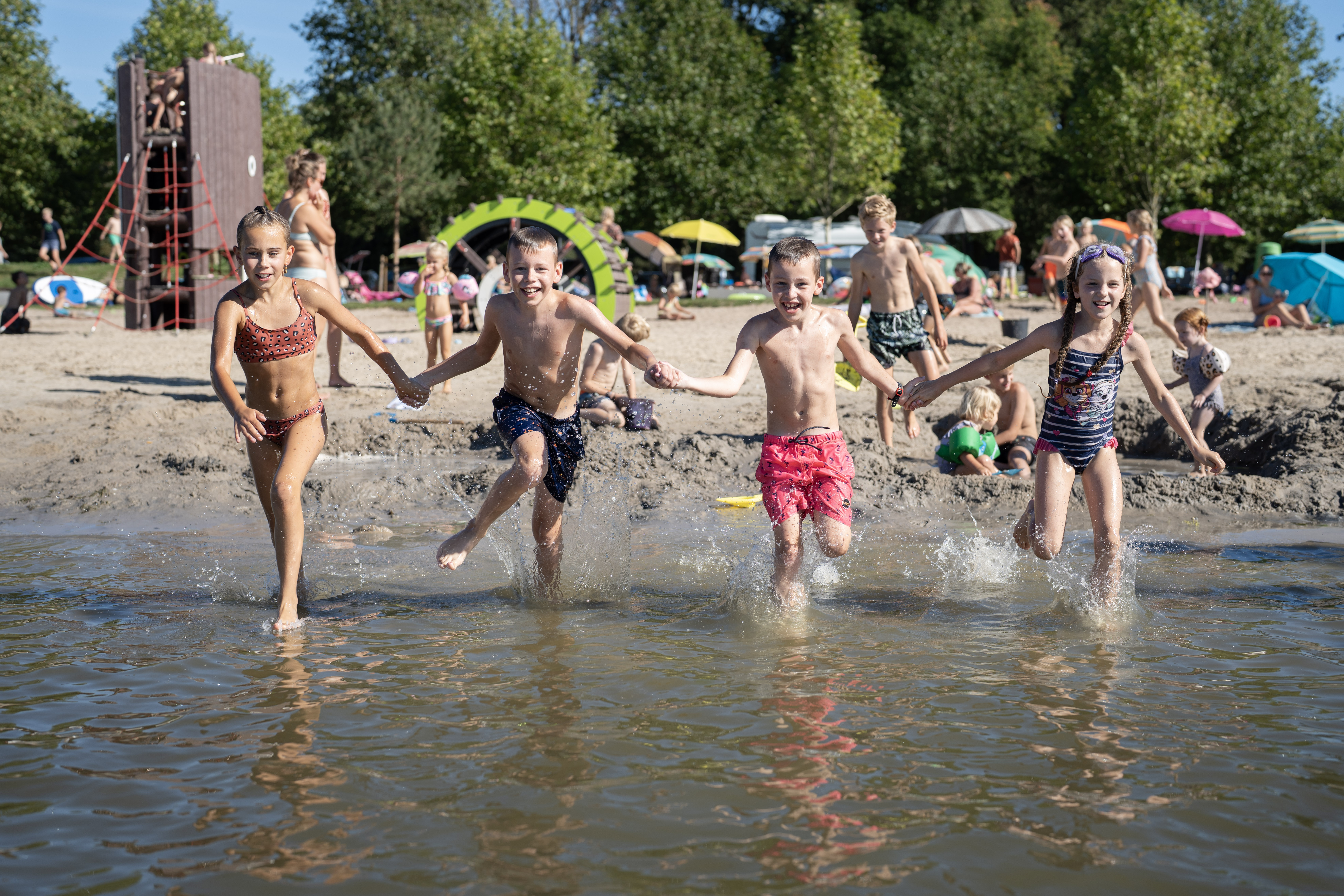 Kinderen rennen water in tijdens hete zomerdag